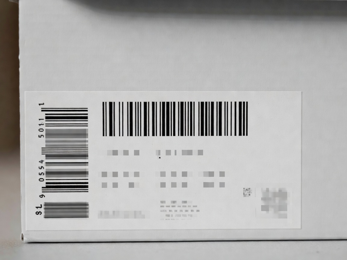 A close up view of a sneaker box label showing sizing, barcode, and style codes